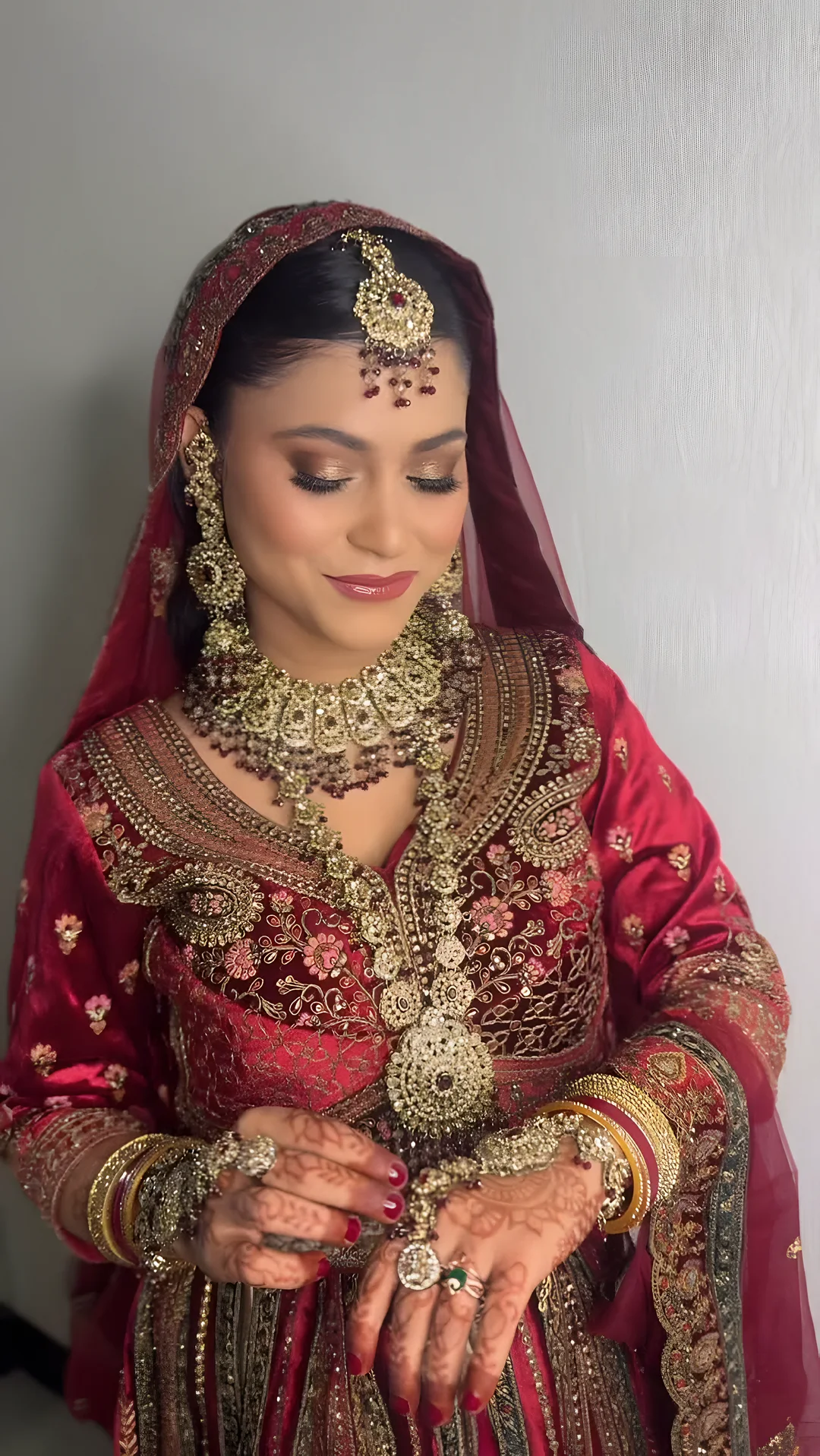 Bride in red with traditional gold jewellery