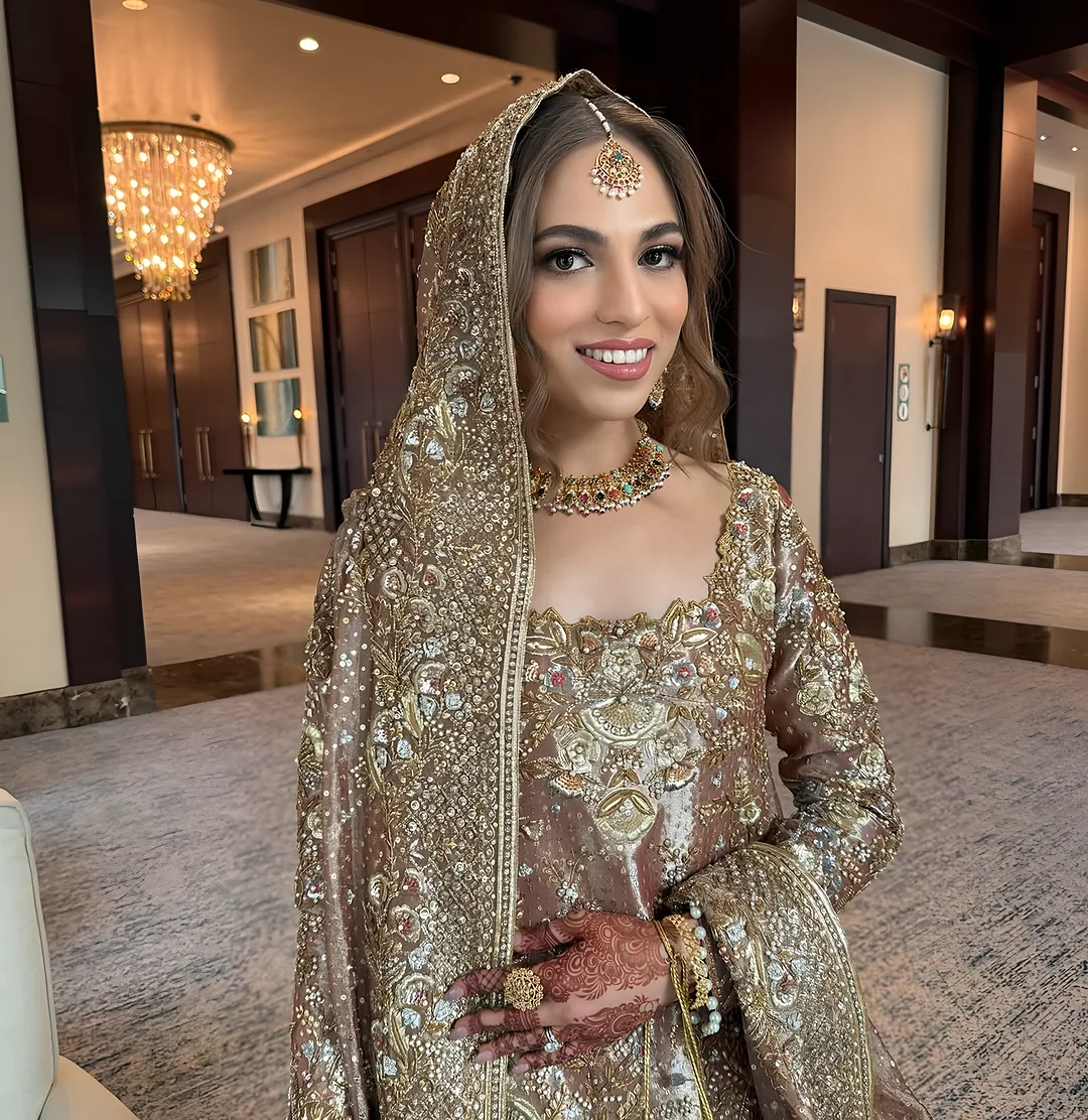 Bride in gold with a dupatta